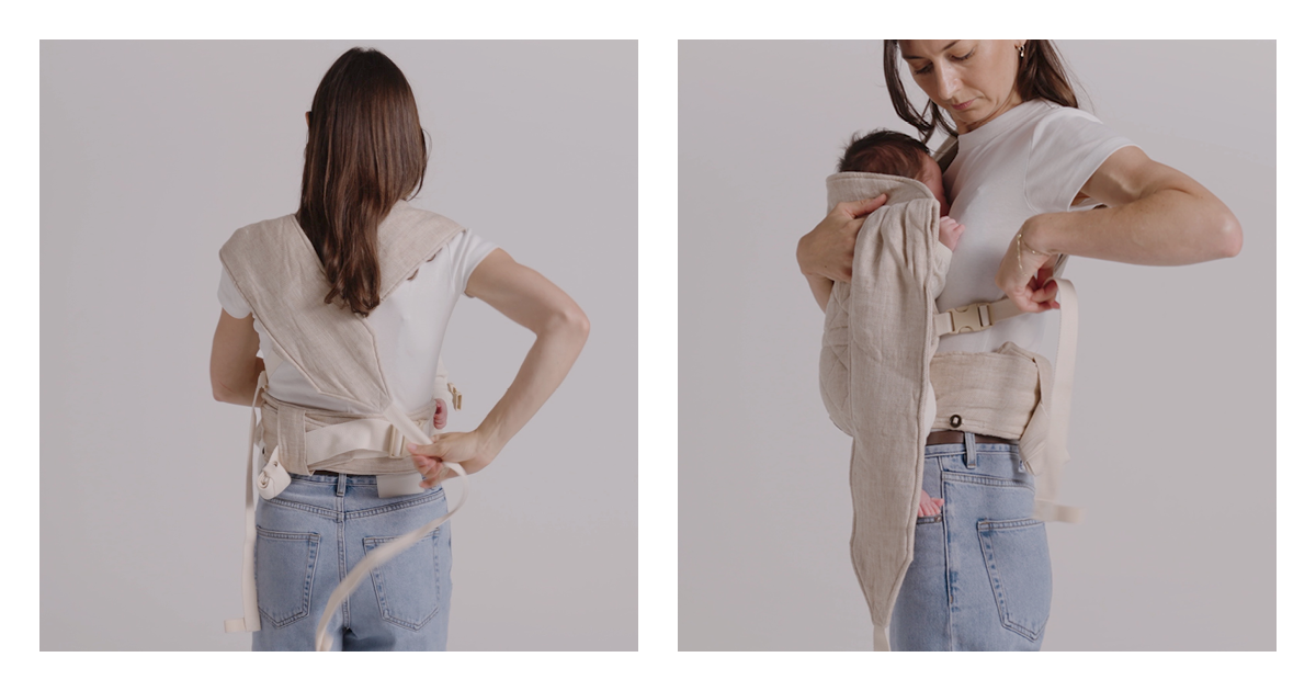 Mum clipping the second Daily baby carrier strap behind her back so the straps cross, newborn settled in the panel