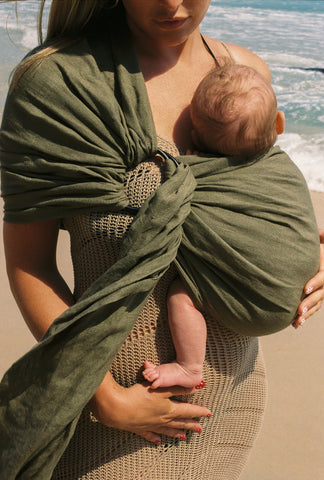 Dark green newborn baby carrier sling made from soft linen.