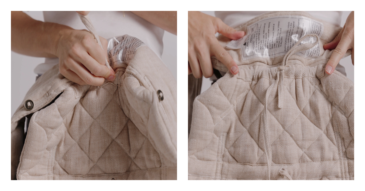 Hands drawing up the adjustable base drawstring inside the quilted linen panel of the Daily baby carrier