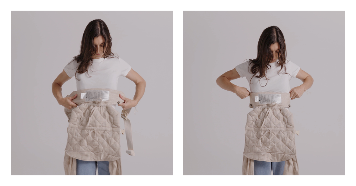 Mum wrapping the apron-style waist belt of the linen Daily baby carrier around her waist, panel hanging in front