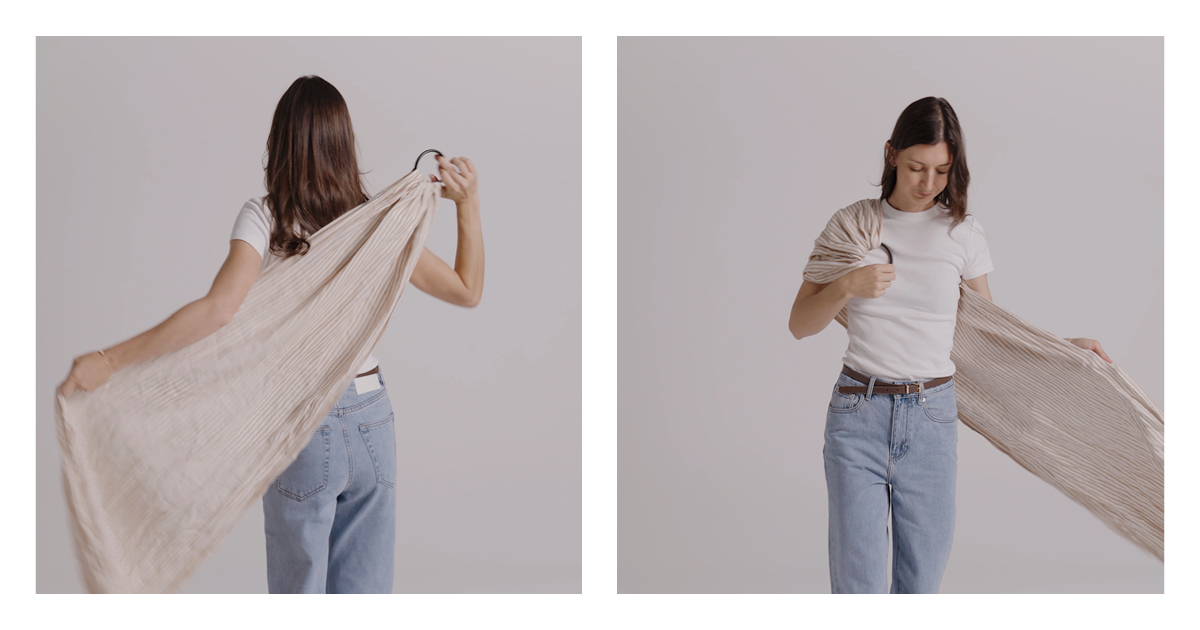 Mum settling the linen ring sling over her shoulder with the rings sitting high and the fabric spread across her back