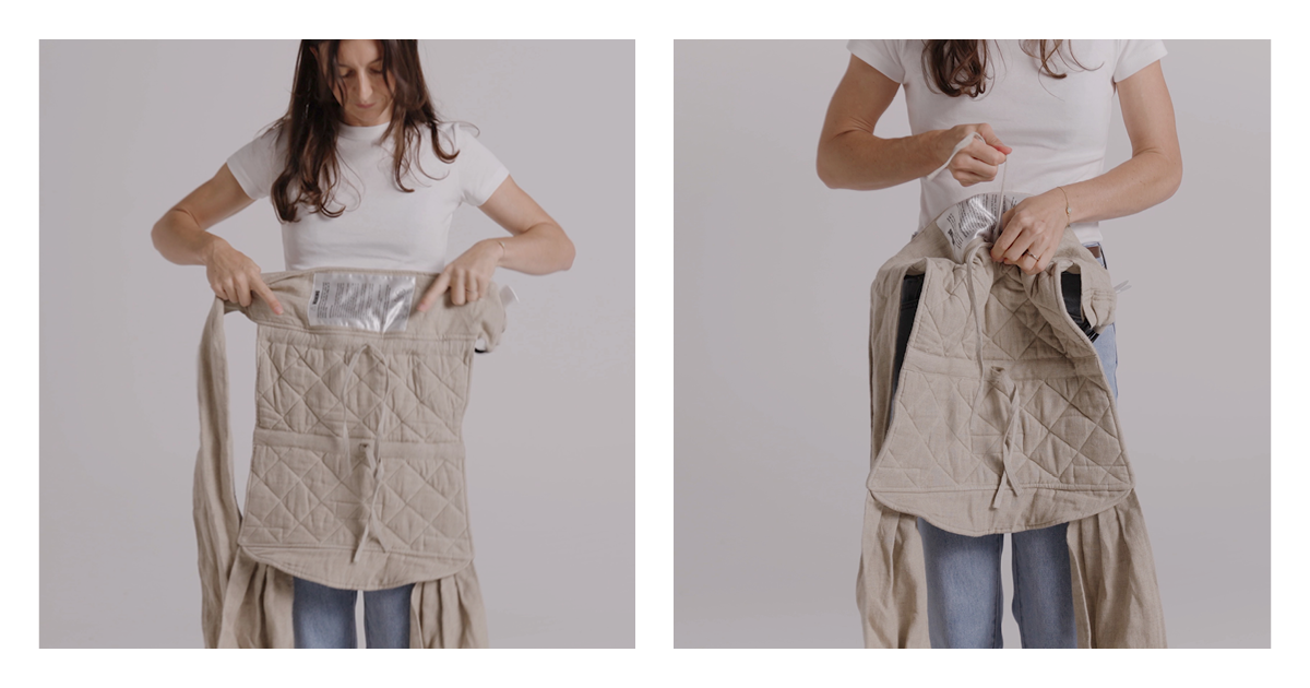 Mum holding the quilted linen panel of the Wrap Carrier at her waist with the long straps hanging loose
