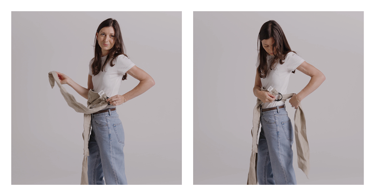 Mum tying the long linen waist straps of the Wrap Carrier around her waist