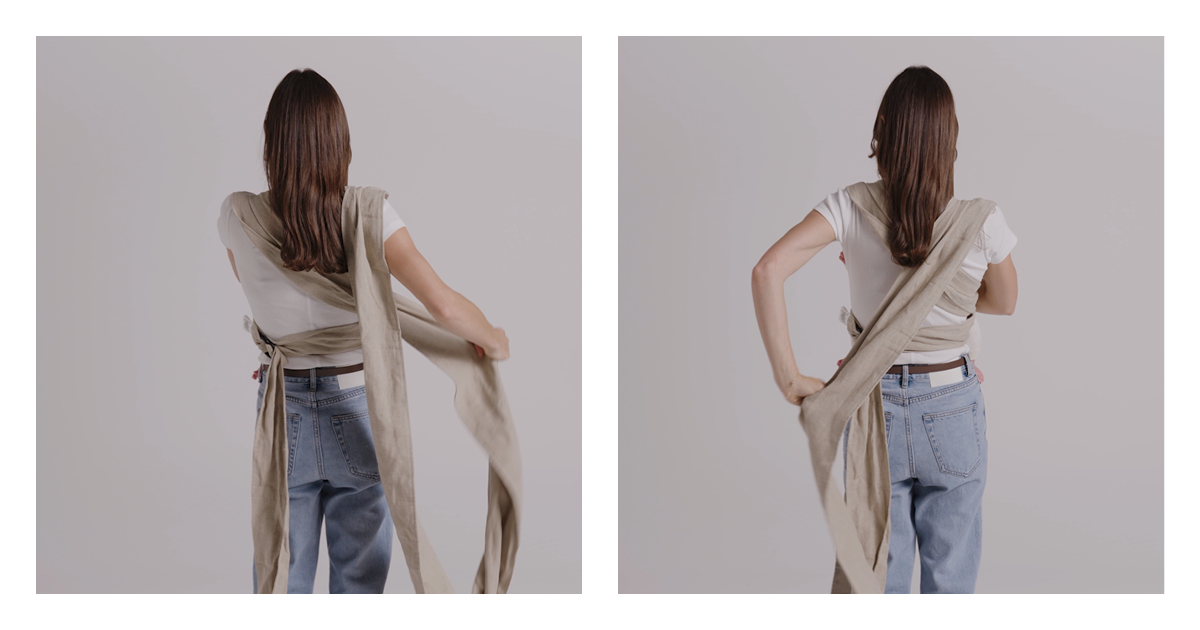 Back view of mum crossing the long linen straps of the Wrap Carrier over her back